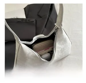 Internal capacity of white faux croc shoulder bag showing phone and wallet