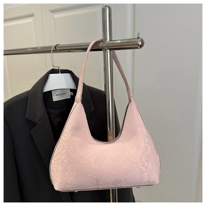 Detail of pink hobo bag featuring fine snakeskin texture and crescent silhouette