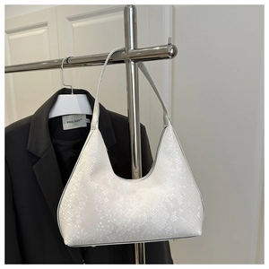 Close-up of white snakeskin texture on a hobo bag with wide shoulder strap