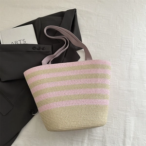 Pink and beige striped woven straw tote bag with wide handles for summer holidays