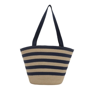 Striped woven straw tote bag with navy shoulder straps for summer beach vacations
