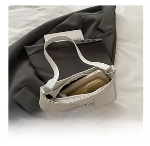 Interior view of white crocodile pattern bag showing high capacity for phone and wallet