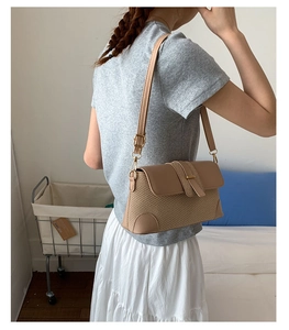 Detail of French vintage baguette bag showing premium leather and straw texture stitching