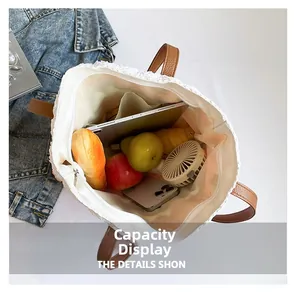 Spacious interior of white striped straw bag showing storage capacity for daily items