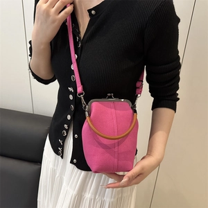 Détail du sac en toile rose avec fermoir rétro en métal et poignée circulaire marron