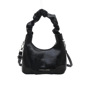 Minimalist black crescent cloud bag with pleated handle and glossy leather finish