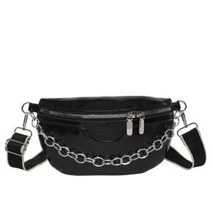 Minimalist black faux leather sling bag with silver chain and woven strap on white background