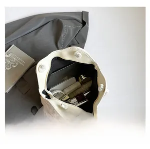 Top view of large capacity straw tote bag interior showing phone and tablet storage