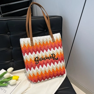 Handwoven straw tote bag with wave stripes, leather handles, and SUMMER embroidery