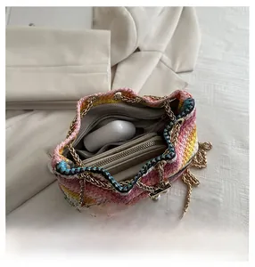 Macro view showing the internal capacity of the colorful woven bucket bag with zipper liner