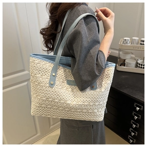 Close-up of geometric lace crochet texture and blue strap on a summer tote bag