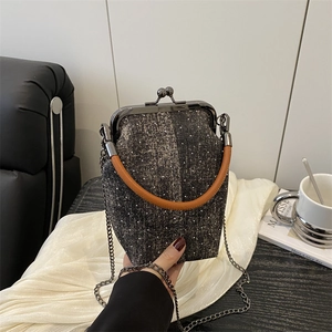 Retro denim-textured doctor bag with brown handles and gunmetal chain strap