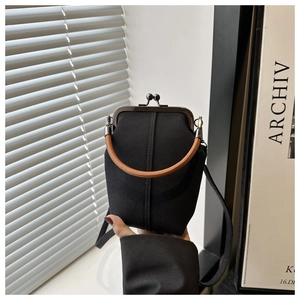 Mini vintage black denim kiss-lock crossbody bag with brown leather handles and strap