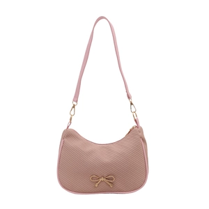 Pink underarm shoulder bag with twill fabric texture and golden bow accessory