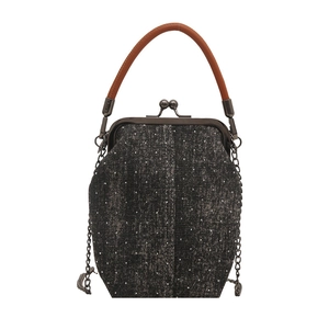 Classic black denim crossbody bag with vintage metal frame and leather top handle