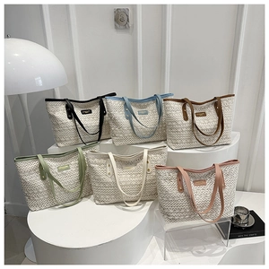 Detailed arrangement of woven tote bags in six colors on minimalist display stands