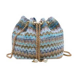 Fashionable woven bucket bag with colorful wavy patterns and pearl drawstring details