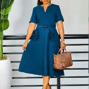 Detail of elegant V-neck dress featuring 3D floral pocket design and matching belt