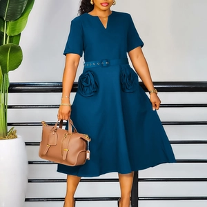 Detail of dark blue V-neck dress featuring unique rose-shaped pockets and belted waist