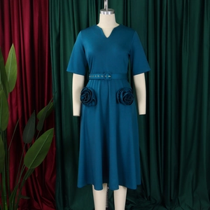 Detail of elegant V-neck peacock blue dress featuring unique 3D rose-shaped side pockets