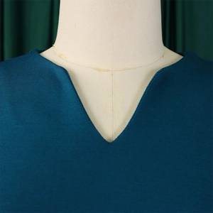 Close-up of minimalist V-neckline and high-quality woven fabric on a navy summer dress