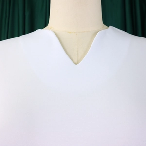 Detail shot of white V-neck dress collar on a mannequin with textured knitted fabric