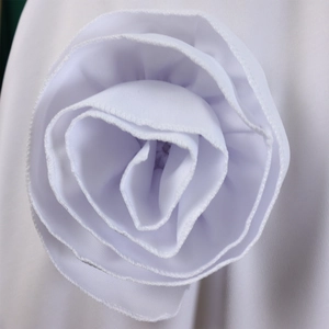Detailed view of handmade white fabric rose featuring multi-layered petal construction