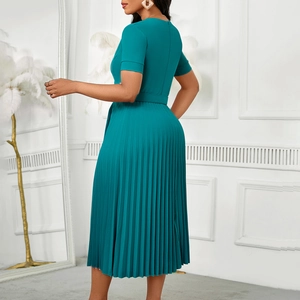 Detail view of the deep teal pleated maxi dress featuring a high-waist belted design
