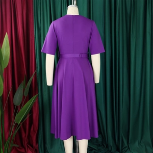 Detail of elegant purple V-neck A-line dress with belt on mannequin display