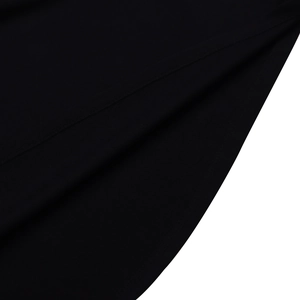 Detailed close-up of premium black knitted fabric texture and high-quality overlock stitching