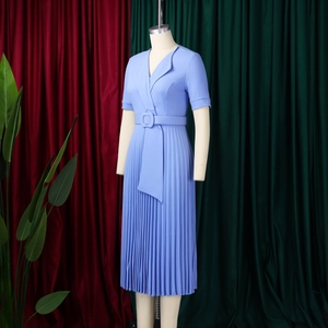 Detail of light blue short sleeve dress featuring elegant pleated skirt and belted waist