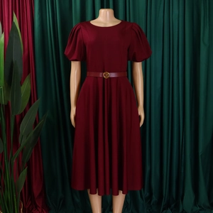 Detail of wine red puff sleeve dress featuring a round neck and matching thin waist belt