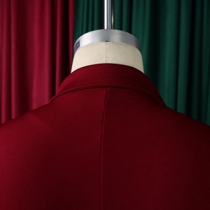 Detail van de donkerrode blazer kraag met fijne textuur en strakke afgewerkte stiknaden