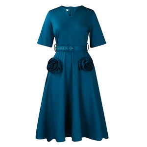 Detail of elegant V-neck dress featuring oversized decorative 3D fabric rose pockets