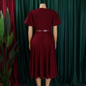 Detailed back view of wine red A-line dress featuring invisible zipper and puff sleeves