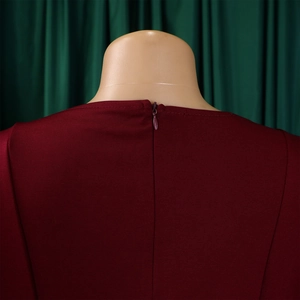 Detail of the elegant wine red A-line dress showing the smooth hidden back zipper and texture