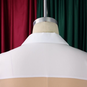 Detail of the white collar stitching and khaki patchwork design on the back of the dress
