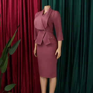 Detail of elegant dusty pink two-piece skirt suit with layered lapel and waist ruffle