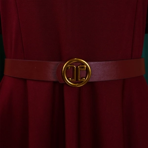 Detail of burgundy A-line dress featuring a waist belt with a gold metallic buckle