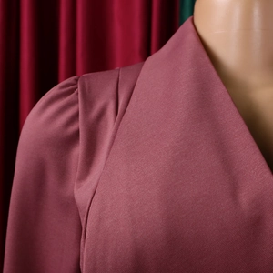 Close-up of lapel collar and puff sleeves on a mauve twill fabric dress