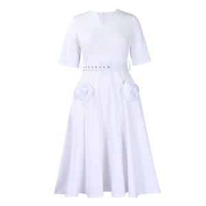 Detail of white A-line dress featuring V-neck, adjustable belt and 3D floral accents