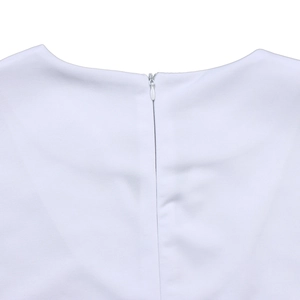 Detail of the white dress featuring a round neckline and hidden zipper closure at back