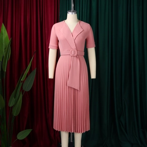 Detail of pink short sleeve V-neck pleated dress with button belt and crisp fabric texture
