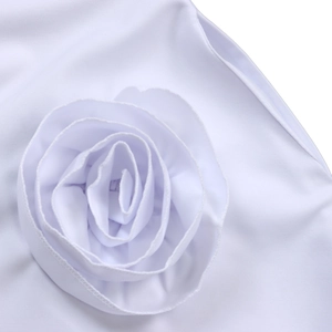 Close-up of elegant handcrafted white fabric 3D rose decoration on V-neck dress