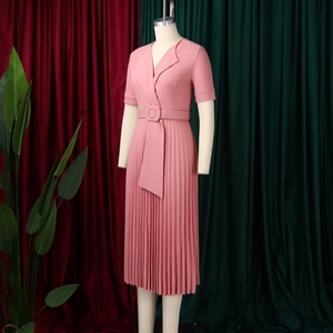 Detail of pink pleated V-neck dress featuring short sleeves and a square buckle waist belt