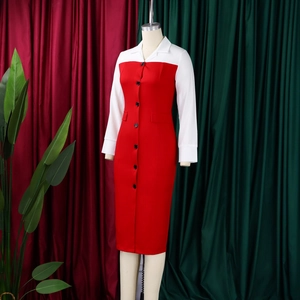 Detail of red business pencil dress with white collar and black buttons on a mannequin