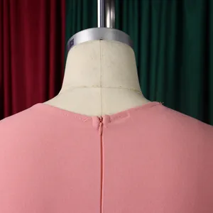 Detail view of pink high-waist dress featuring a hidden zipper and crepe fabric texture