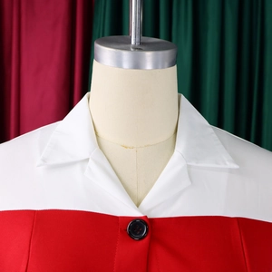 Close-up of contrast lapel collar with black button on a red and white professional dress