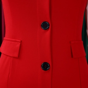 Detail of red blazer fabric with textured weave and two black resin buttons