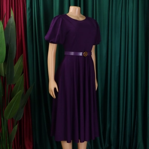 Detailed view of purple A-line dress with puff sleeves and waist belt on mannequin